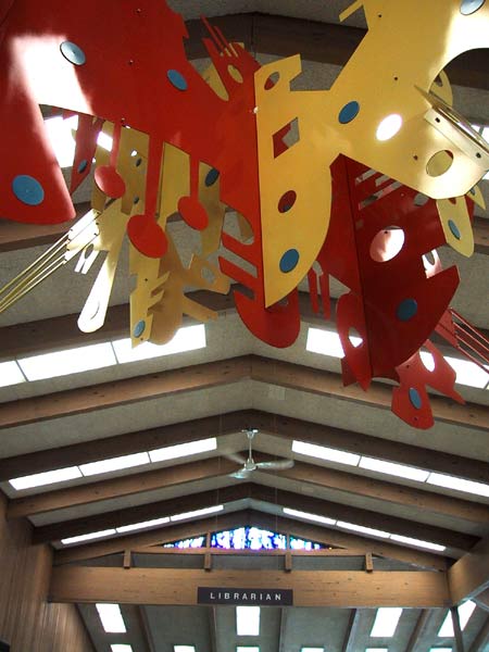 [Spatial and lovely on the inside. How would you like to be the librarian that got to work under this sign? This library was filled with schoolkids and bit bright posters from ALA talking about the library, and how cool it is to read.
]